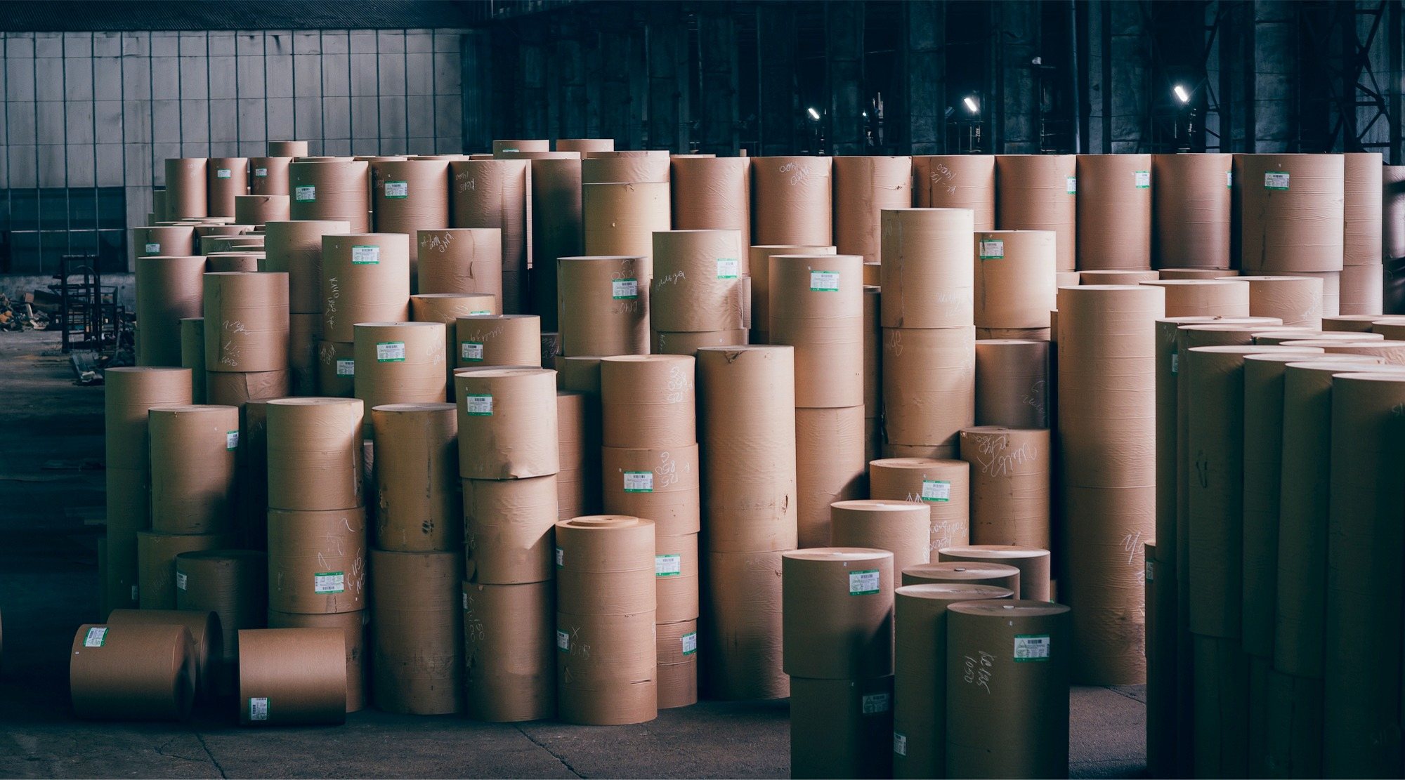 Rolls of kraft paper stacked in a warehouse